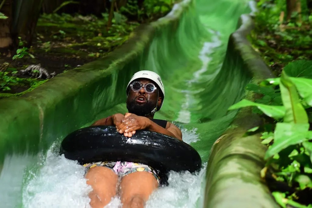 Guest riding the 400-meter jungle water slide at Rincón Thermals & Adventures