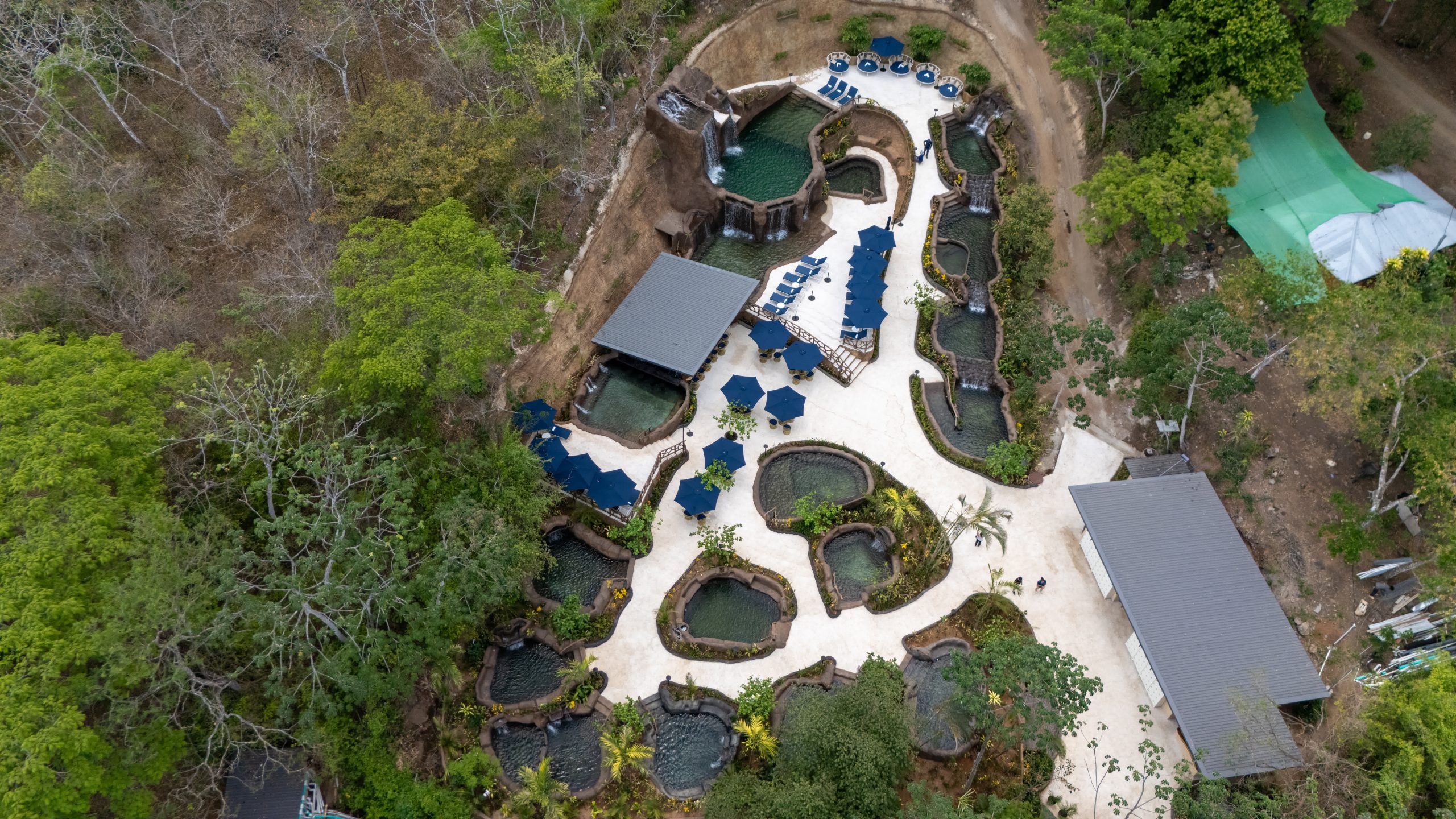 Aerial view of Rincon Thermals cascading volcanic pool complex surrounded by lush Costa Rica rainforest