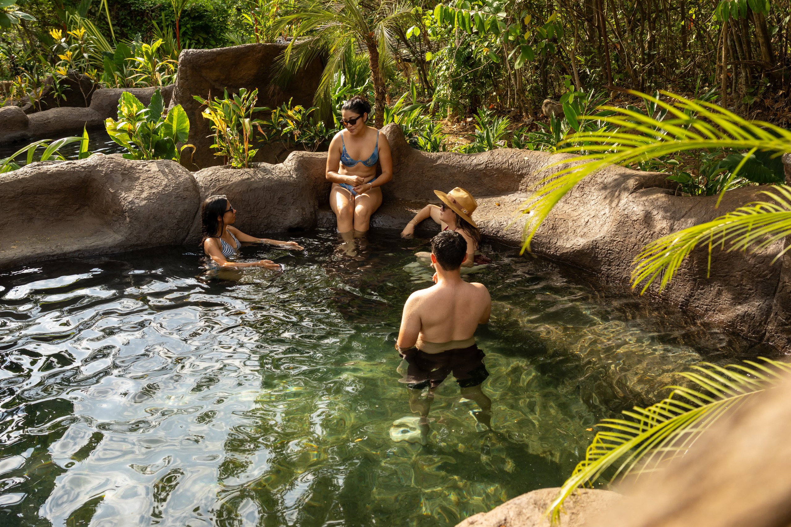 Guests relaxing in the Rincón Thermal Day Pass volcanic pools